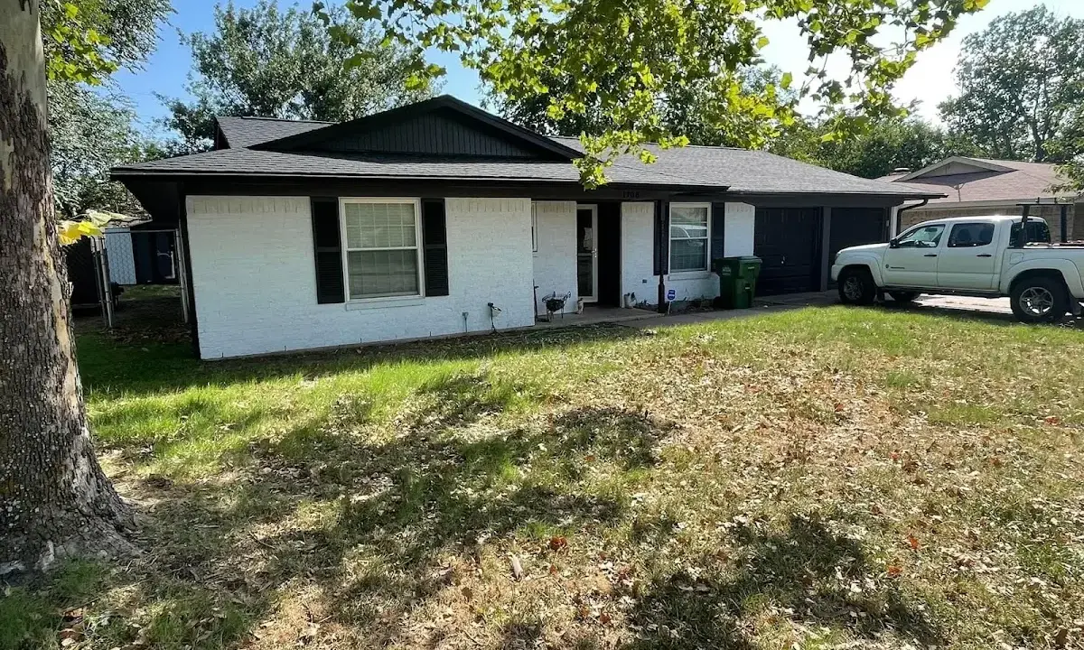 Professional roofing crew working on a residential roof in Rome